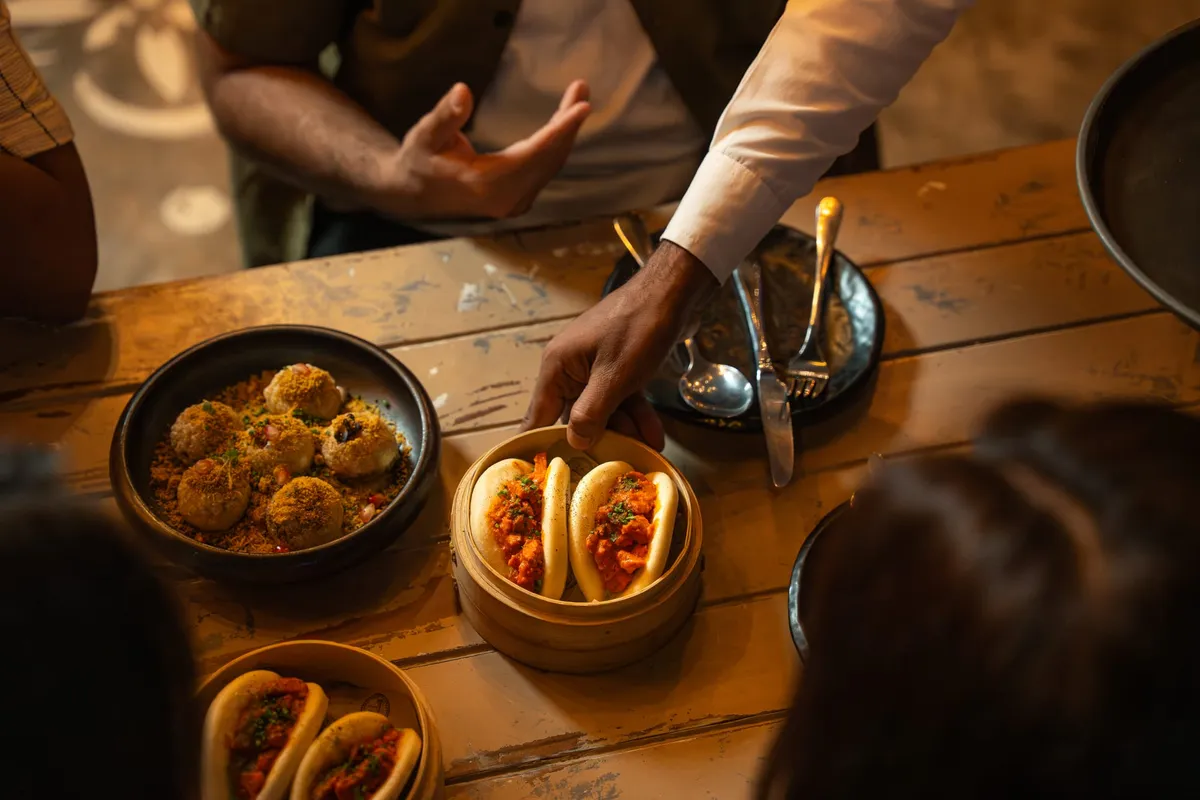 Interior of Farzi Cafe showing contemporary dining room with warm lighting and artistic décor.