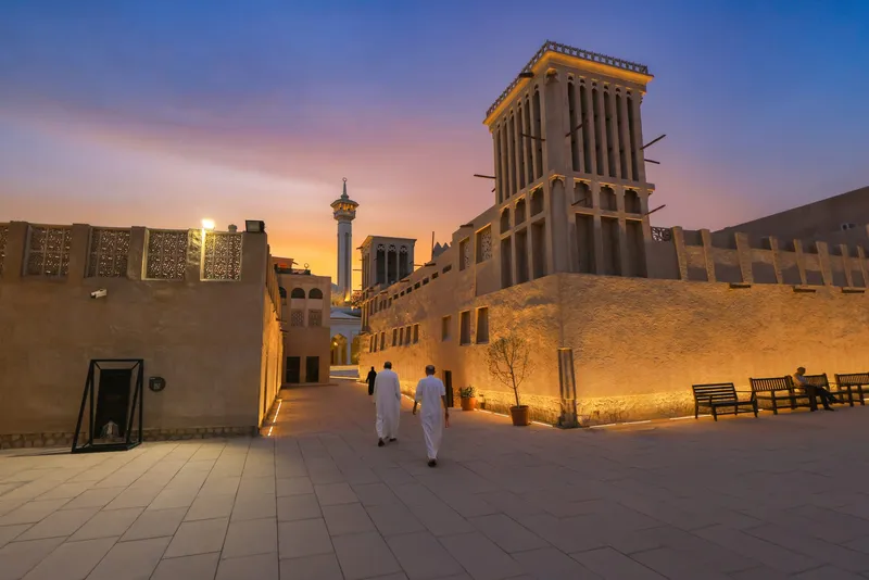 Al Shindagha heritage district waterfront illuminated at night along Dubai Creek