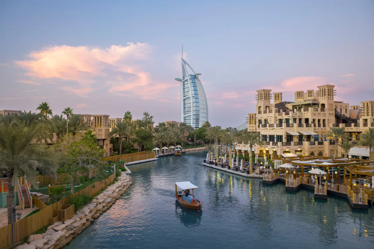 A Dubai rooftop terrace overlooking the city skyline at dusk.