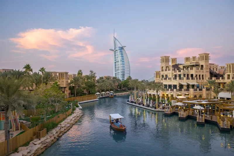 A Dubai rooftop terrace overlooking the city skyline at dusk.