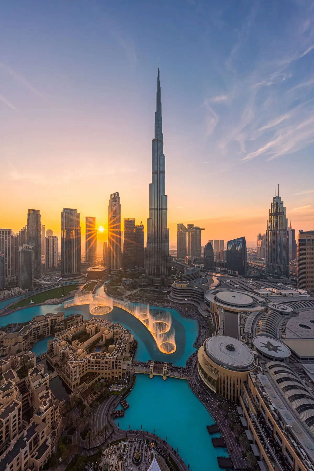 Burj Khalifa rising above Downtown Dubai against a clear sky.
