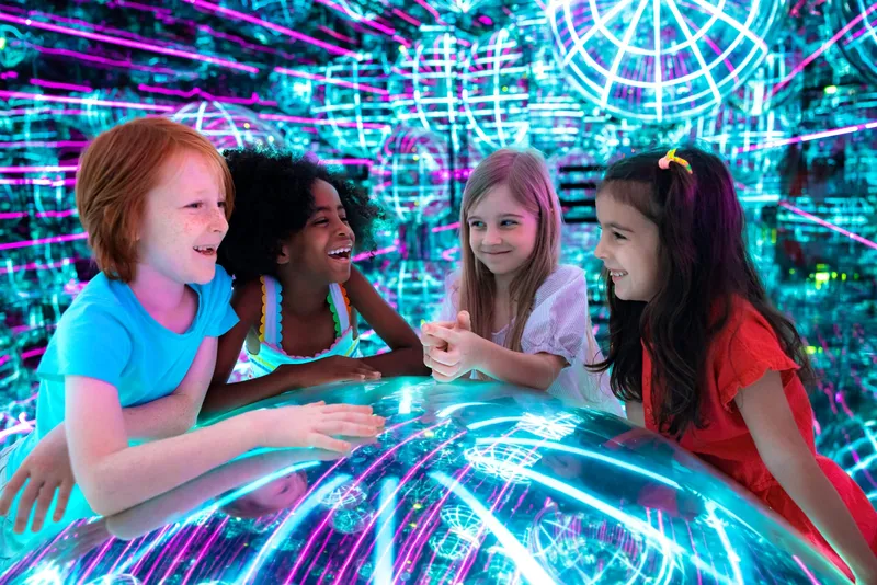 Families enjoying the immersive light and art experience at AYA Dubai in Wafi Mall