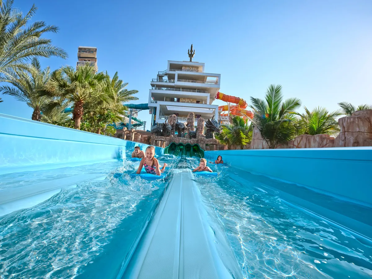 Families enjoying Aquaventure water park's lazy river and wave pool at Atlantis, The Palm