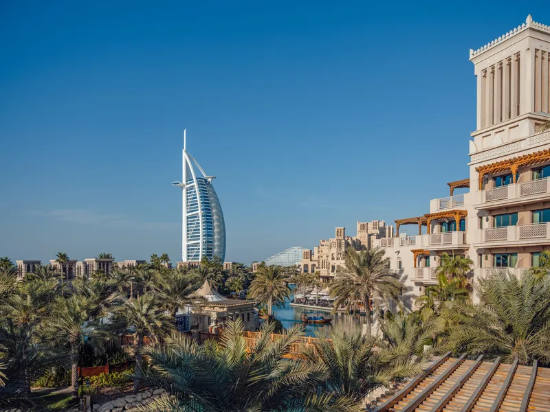 Madinat Jumeirah waterways and traditional wind-tower architecture with Burj Al Arab in the background